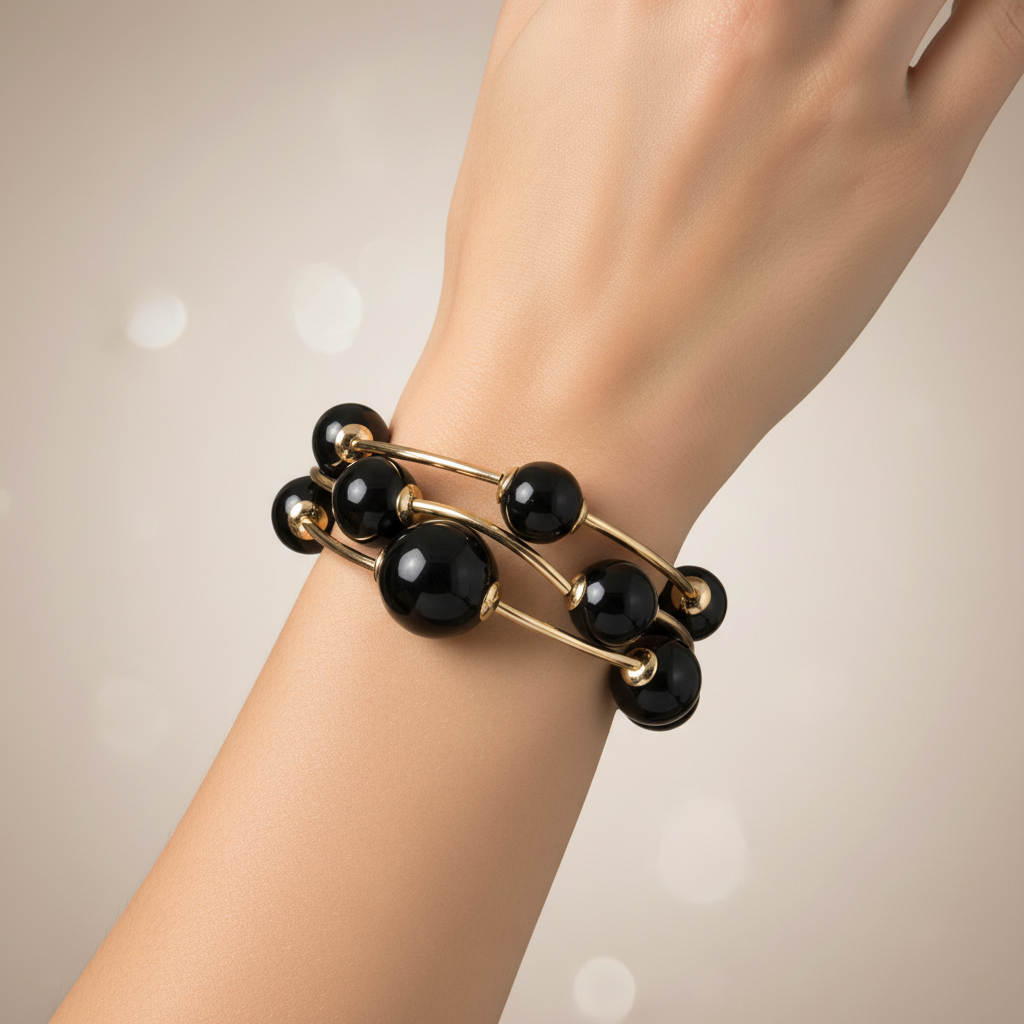 Black beaded bracelet with gold accents on a white background