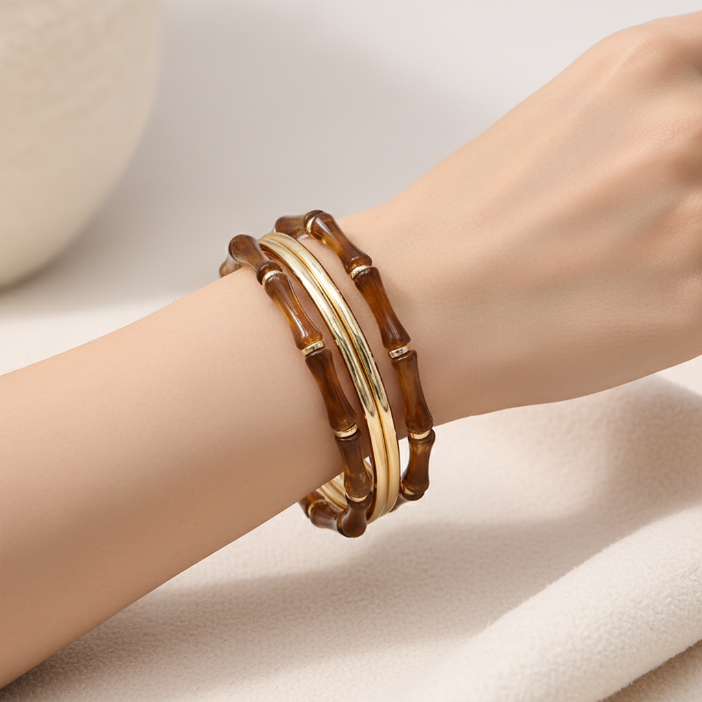 Set of brown and gold bangles on a white background