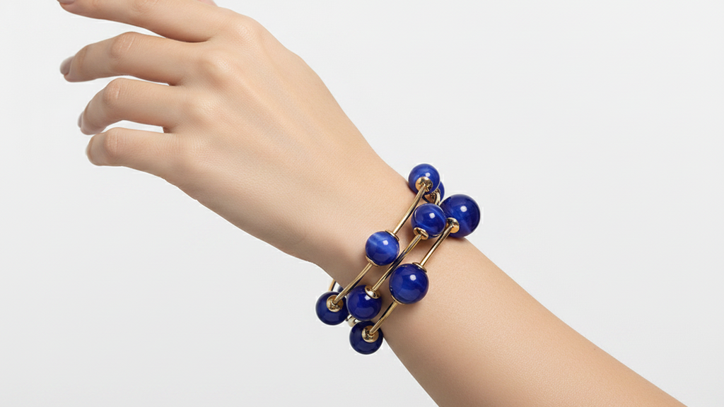 Set of blue beaded bracelets with gold accents on a white background