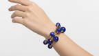 Set of blue beaded bracelets with gold accents on a white background