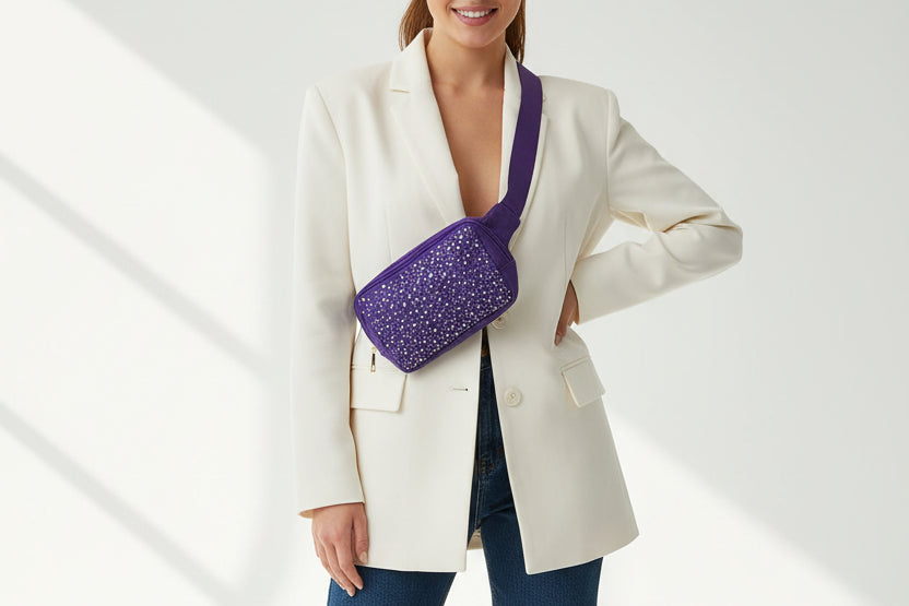 Purple cosmetic bag with rhinestone embellishments on a white background