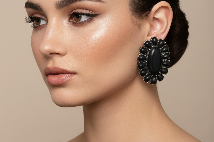 Pair of black stone earrings on a white background