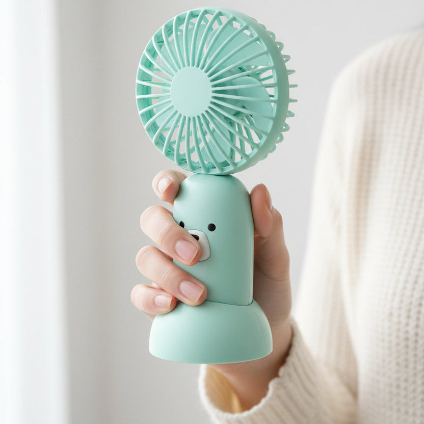 Mint green fan shaped like a bear on a white background