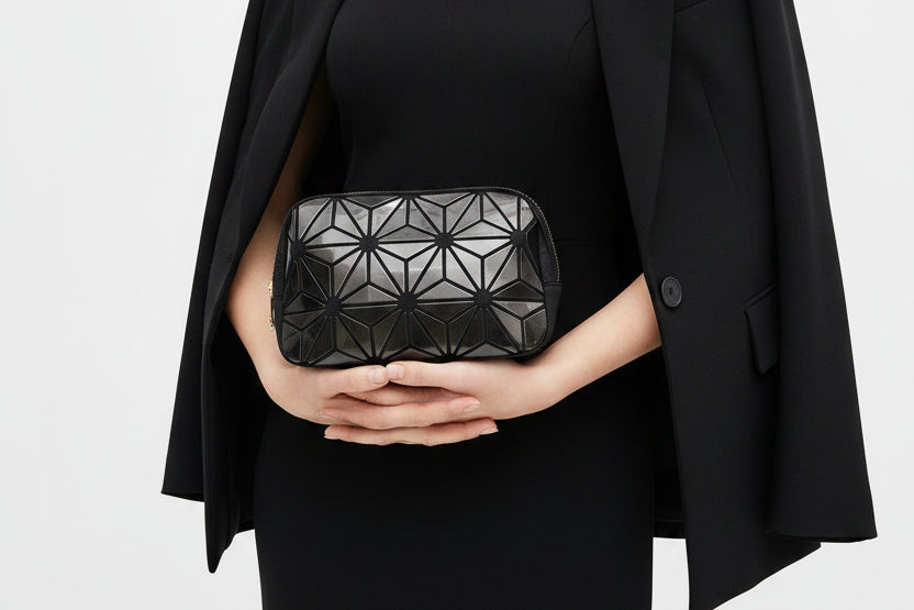 Black geometric patterned pouch on a white background