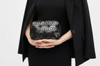Black geometric patterned pouch on a white background