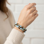 Bracelet with blue beads and brown beaded accents on a white background
