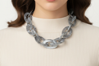 Silver chain necklace on a mannequin bust against a white background