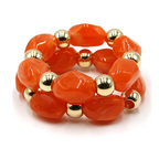 Two piece marbled oval bead stretch bracelet with gold tone accents.