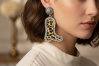 Cowboy boot earrings with leopard print design on a white background