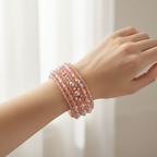 Pink beaded bracelet with multicolor accents on a white background