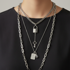 Multi-layered necklace with various pendants on a mannequin bust.