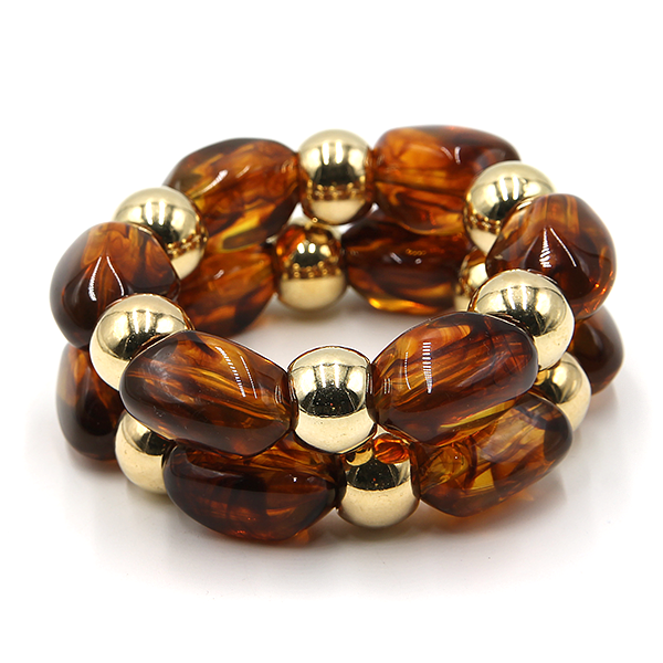Two piece marbled oval bead stretch bracelet with gold tone accents.