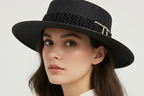 Black straw hat with a gold chain on a white background
