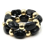Two piece marbled oval bead stretch bracelet with gold tone accents.