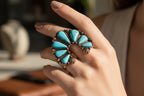 Turquoise stone brooch with bronze setting on a white background