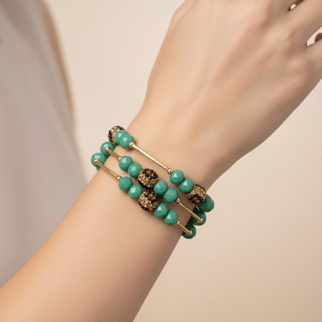 Set of green beaded bracelets with gold accents on a white background
